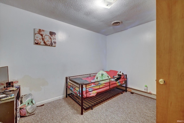 bedroom featuring carpet flooring and a textured ceiling