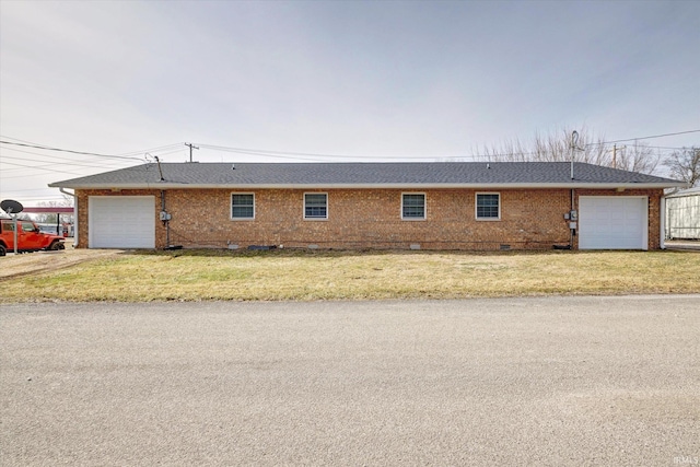 view of property exterior featuring a garage and a lawn