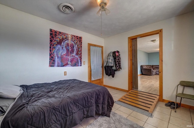 bedroom featuring light tile patterned floors and ceiling fan