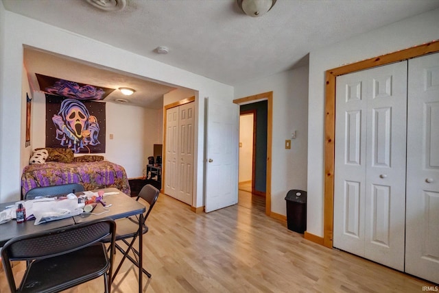 bedroom with light hardwood / wood-style floors and a textured ceiling