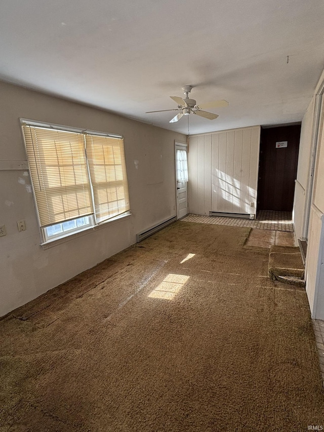 carpeted empty room with a baseboard radiator and ceiling fan