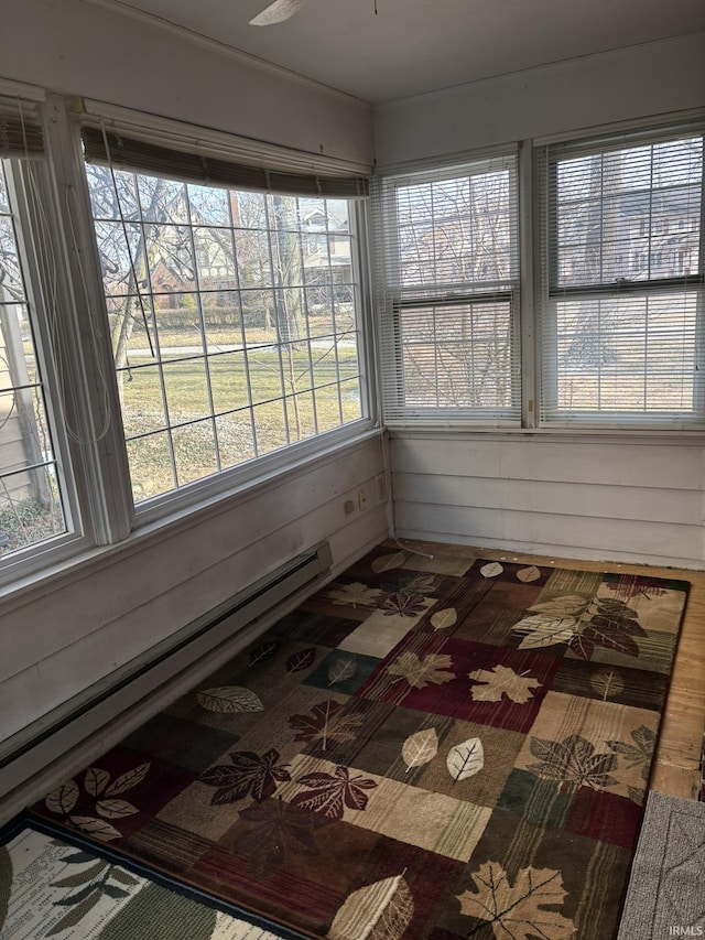 unfurnished sunroom featuring baseboard heating