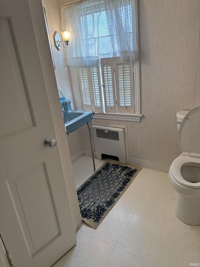 bathroom featuring sink, radiator heating unit, toilet, and tile patterned flooring