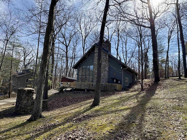 view of home's exterior with a wooden deck