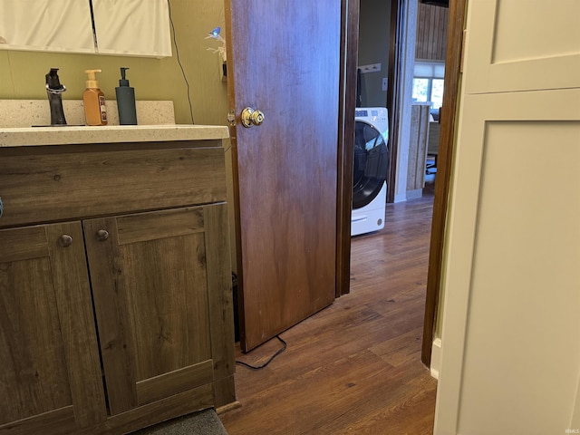 interior space featuring washer / dryer, dark hardwood / wood-style flooring, and sink