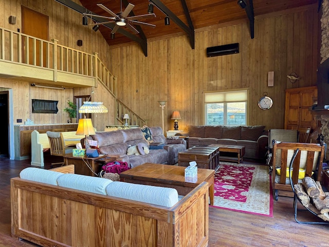 living room with hardwood / wood-style flooring, beam ceiling, wood walls, wooden ceiling, and ceiling fan