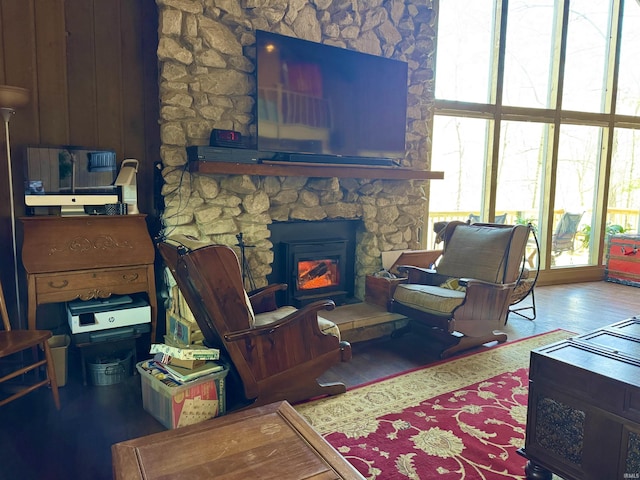 living room featuring hardwood / wood-style flooring and a stone fireplace