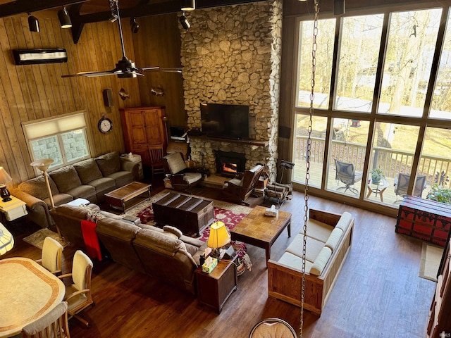 living room with a fireplace, plenty of natural light, and dark hardwood / wood-style flooring