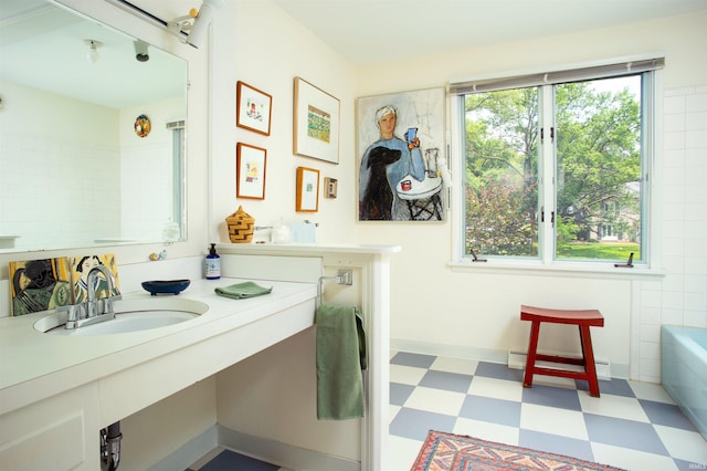 bathroom with vanity and a baseboard heating unit