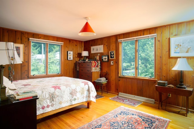 bedroom featuring baseboard heating and light wood-type flooring