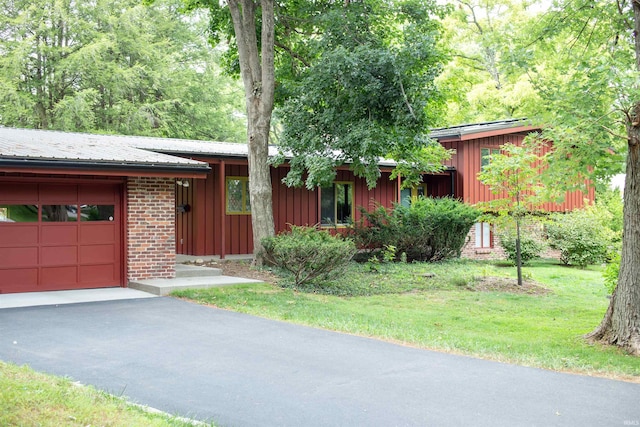 view of front of property with a garage and a front lawn