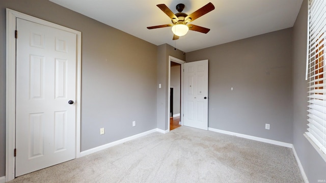 unfurnished bedroom with light carpet and ceiling fan