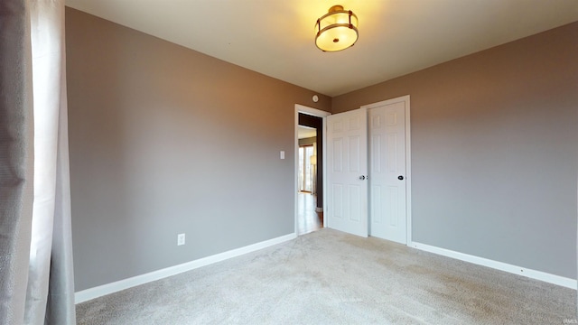 unfurnished bedroom with a closet and carpet flooring