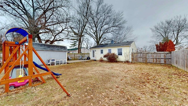 view of yard featuring a playground and an outbuilding