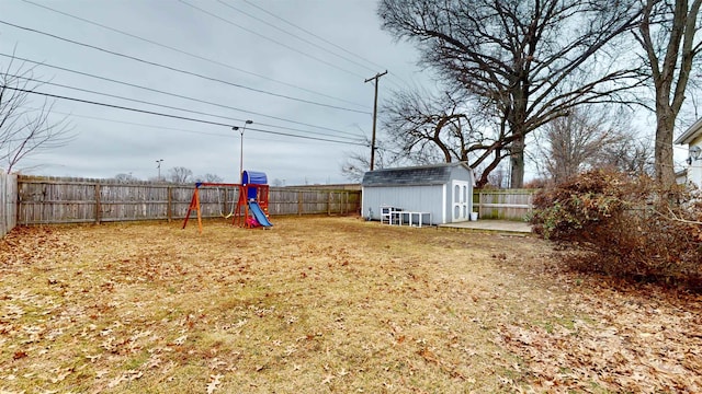 view of yard with a playground and a shed