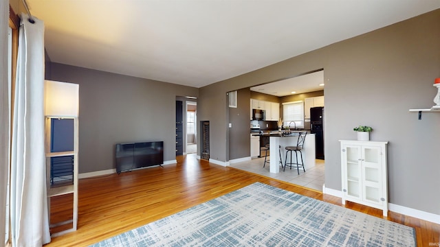 living room with sink and light hardwood / wood-style floors