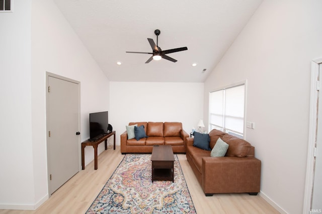 living room featuring ceiling fan, high vaulted ceiling, and light hardwood / wood-style floors