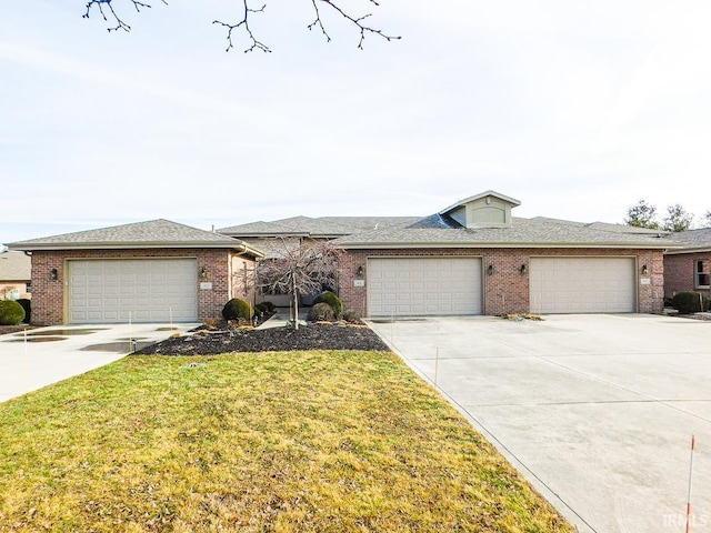 single story home featuring a garage and a front yard