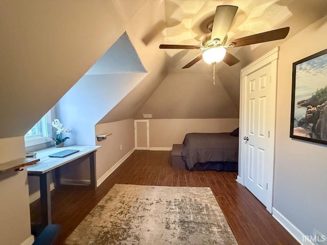 unfurnished bedroom with lofted ceiling, dark wood-type flooring, and ceiling fan