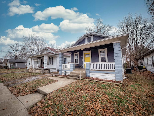 bungalow-style house featuring central AC unit and a porch