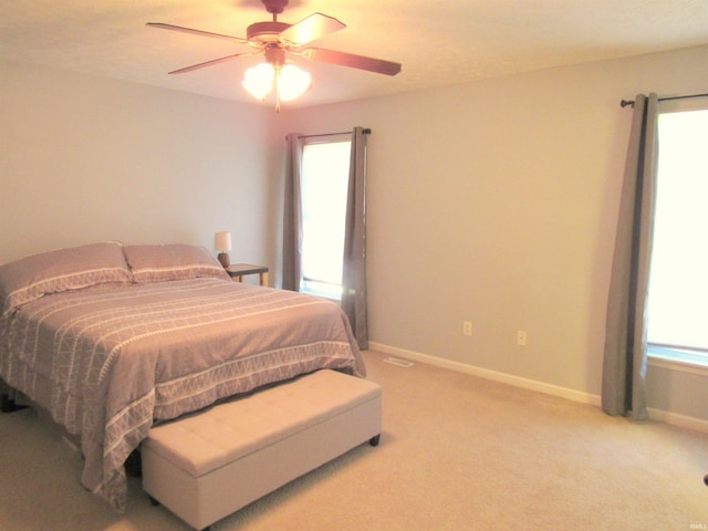 bedroom with ceiling fan and light colored carpet