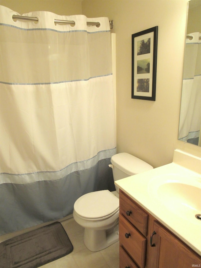 bathroom featuring tile patterned flooring, vanity, and toilet