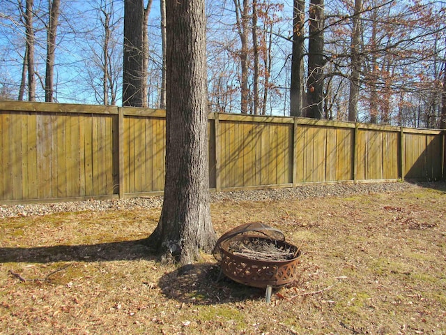 view of yard with a fire pit