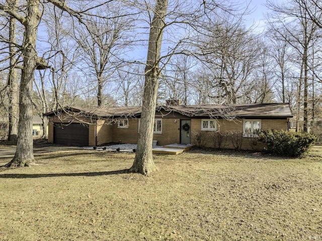 view of front of house with a garage and a front lawn