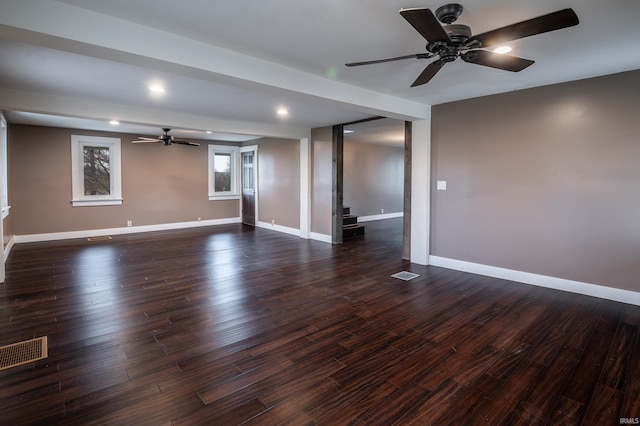 empty room with dark wood-type flooring and ceiling fan