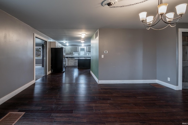 interior space featuring dark hardwood / wood-style flooring and a chandelier