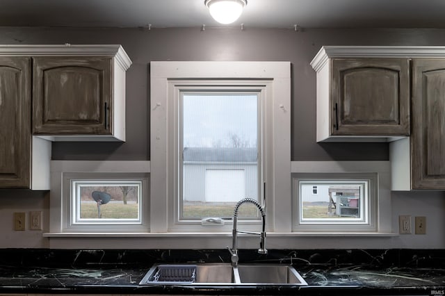 kitchen featuring sink and dark brown cabinets