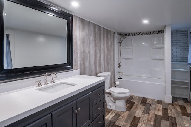 full bathroom with shower / bathing tub combination, hardwood / wood-style floors, vanity, and toilet