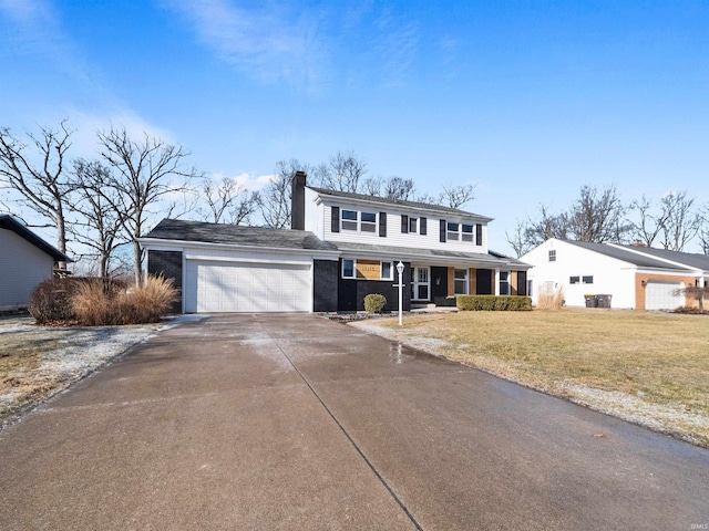 view of front of house with a garage, covered porch, and a front yard