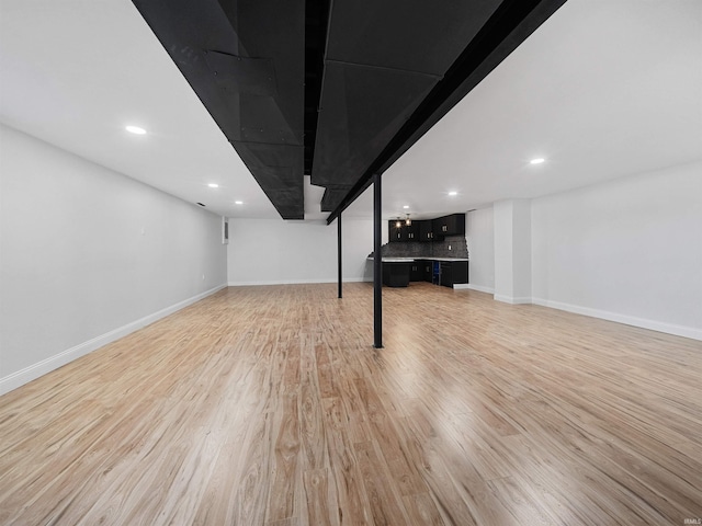 basement featuring light hardwood / wood-style floors