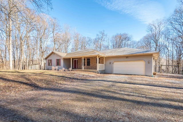 ranch-style house with a garage and a porch