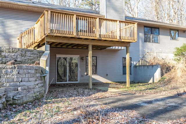 rear view of house featuring a deck