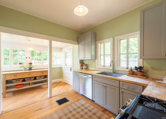 kitchen featuring dishwasher, sink, hanging light fixtures, and gray cabinetry