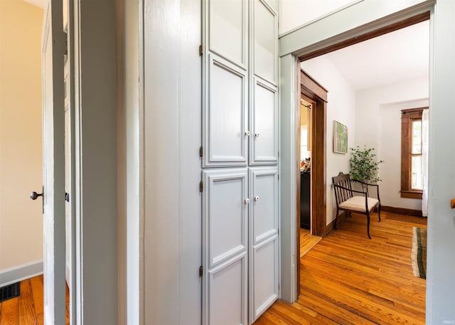 hallway with light hardwood / wood-style flooring