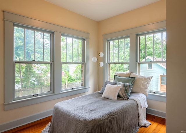 bedroom featuring multiple windows and light wood-type flooring