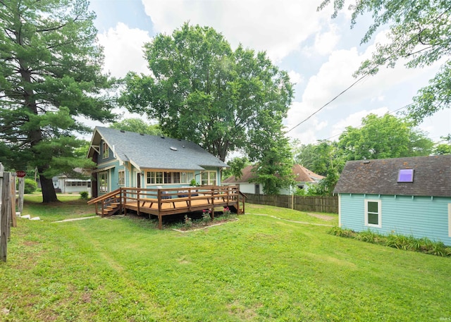 back of house featuring a wooden deck and a yard