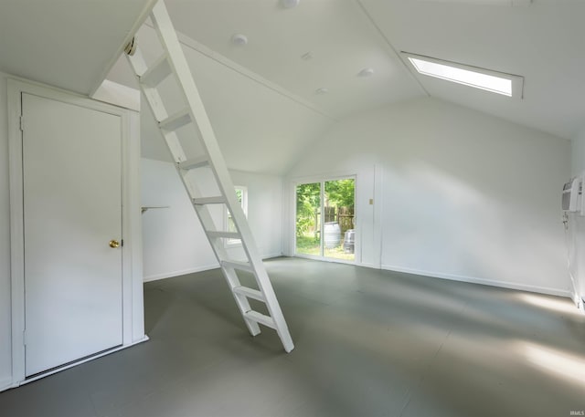 additional living space featuring vaulted ceiling with skylight