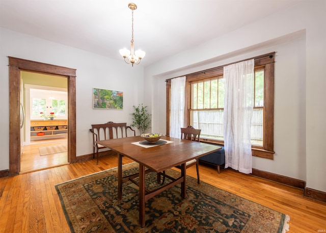 dining space with a chandelier and light hardwood / wood-style flooring