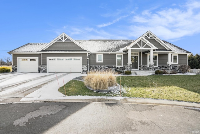 craftsman inspired home featuring a garage and a front yard