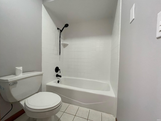 bathroom featuring tile patterned flooring, tiled shower / bath, and toilet