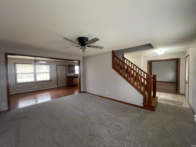 unfurnished living room featuring ceiling fan, carpet, and baseboard heating