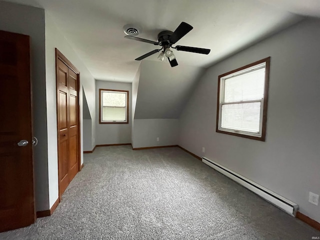 bonus room featuring lofted ceiling, carpet, ceiling fan, and baseboard heating