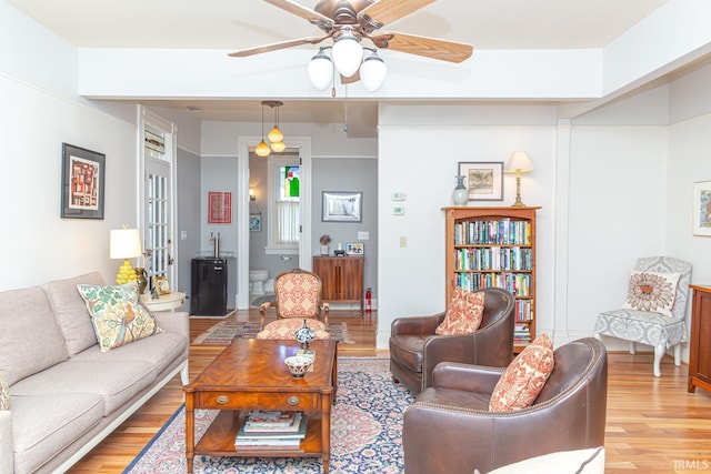 living room featuring ceiling fan and light hardwood / wood-style floors