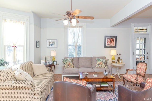 living room featuring hardwood / wood-style flooring, a healthy amount of sunlight, and ceiling fan