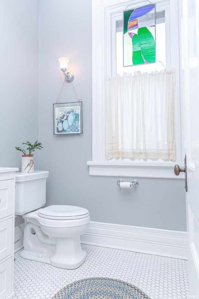 bathroom featuring tile patterned floors, toilet, and vanity