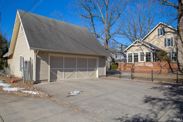 view of side of property featuring a wooden deck and a garage